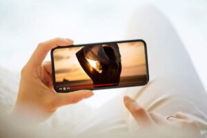 woman watching video mobile phone 1024x683 1